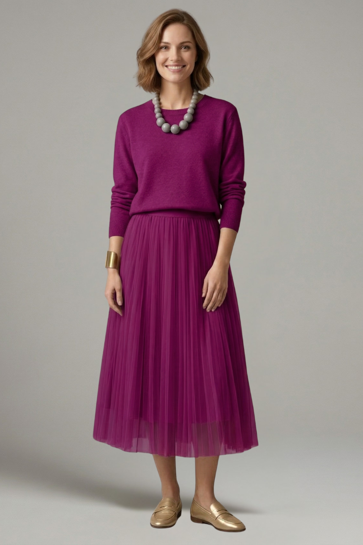 Detail view: Elegant women's layered dress, highlighting the pleated midi skirt, long sleeves, and round neck design.