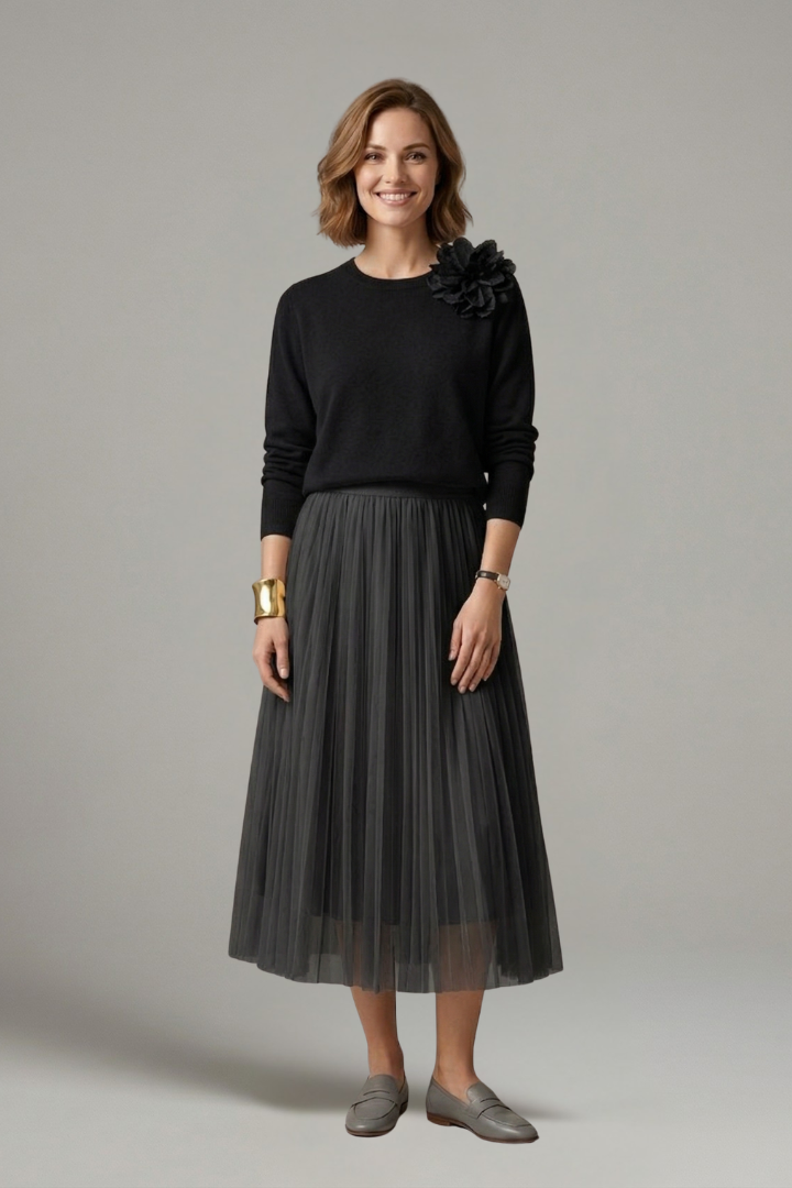 Fashionable women's elegant layered dress featuring a pleated midi skirt. Great for formal events or a chic casual look.