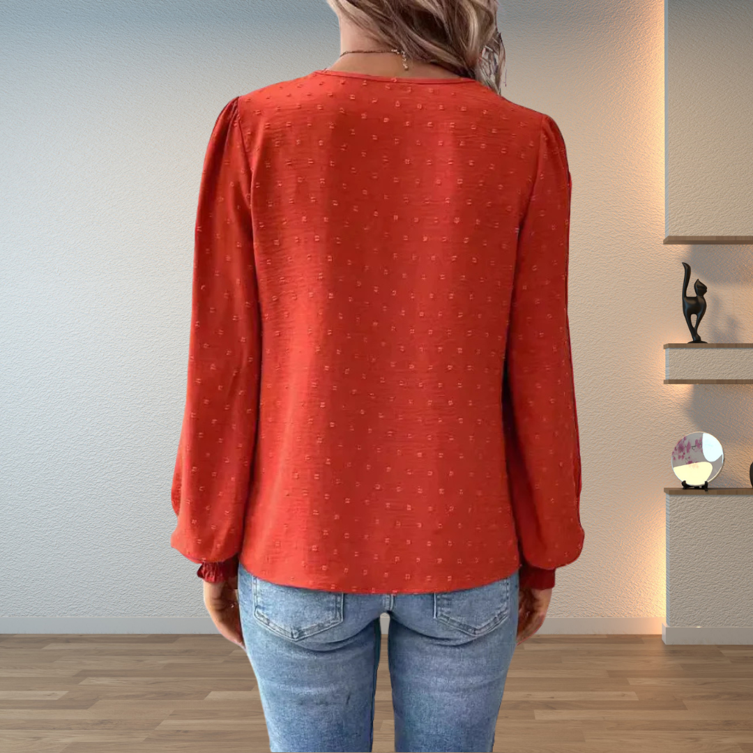Terracotta women's blouse featuring delicate lace trim, a stylish v-neck, and comfortable long sleeves.