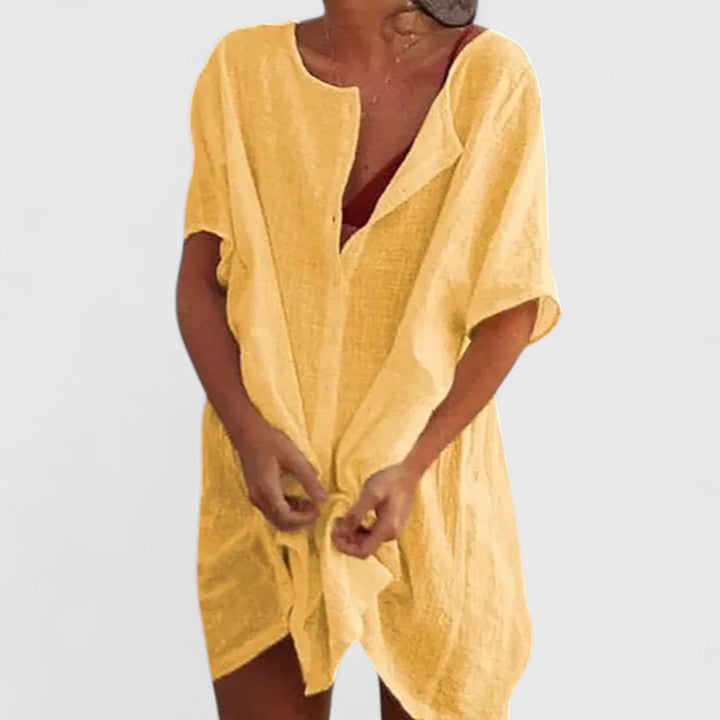 Women's lightweight summer tunic dress with accessories, styled for an elegant beach vacation look.