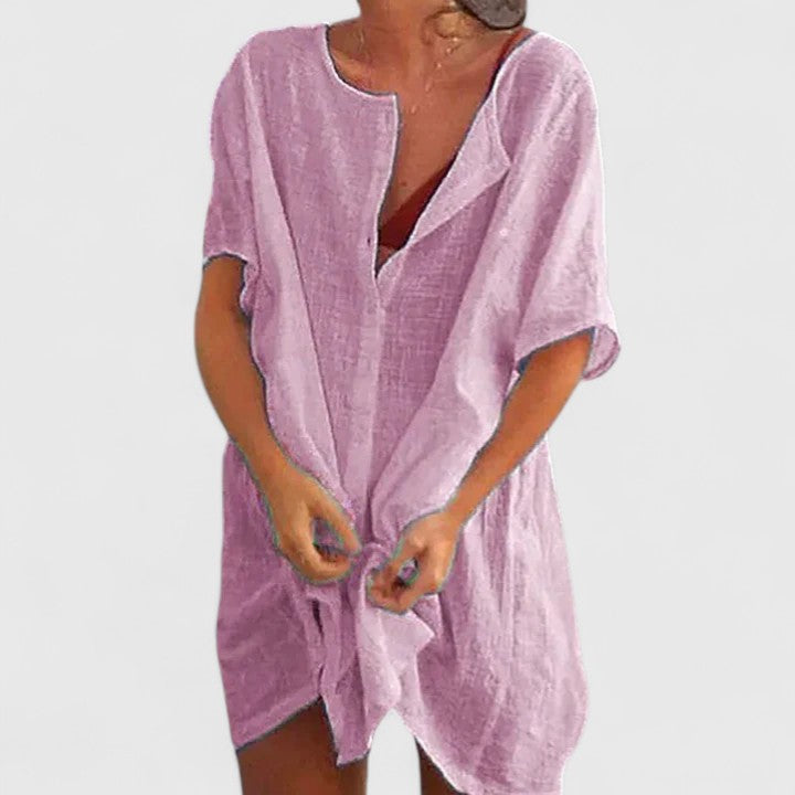 Model in relaxed fit short sleeve tunic dress, ideal for warm weather day-to-night style.