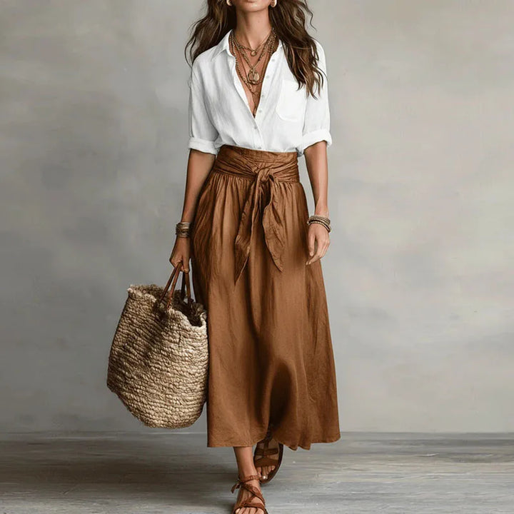 Versatile women's two-piece skirt suit with a long-sleeve top and matching skirt for a polished, modern look.