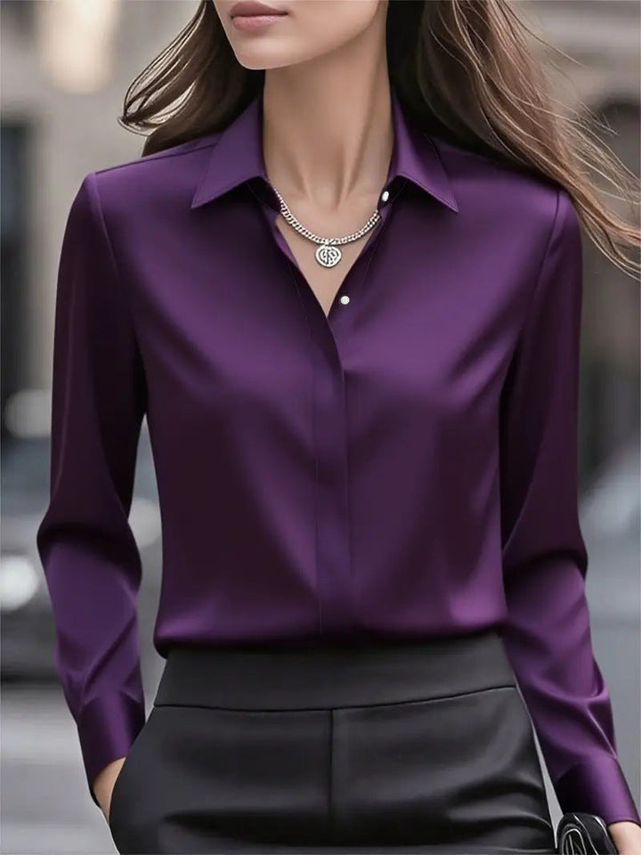 Back view: women's luminous long sleeve button blouse, revealing its smooth fabric and professional cut.