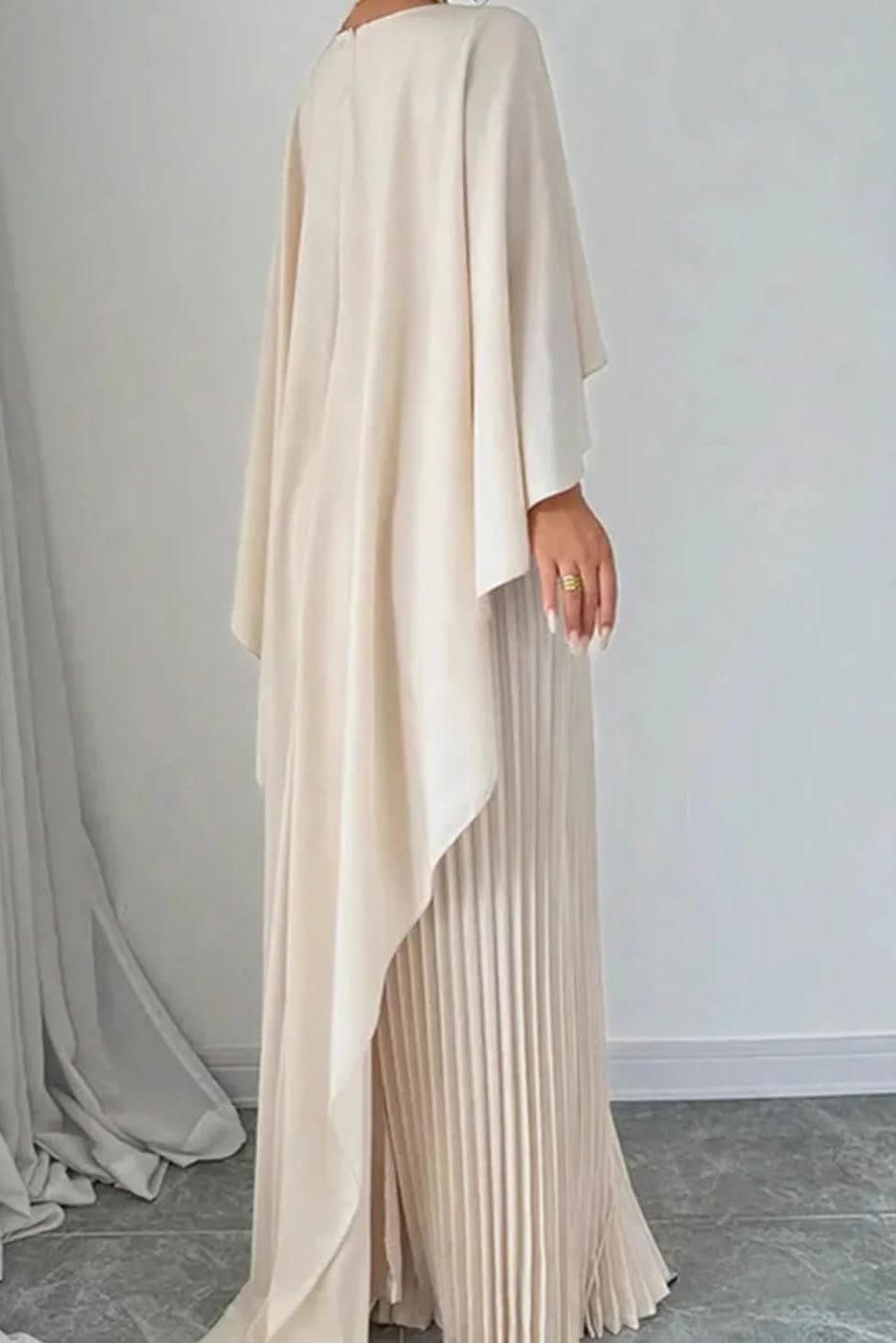 Close-up of a luxurious pleated cape on a women's maxi dress, ideal for an elegant evening or gala event.