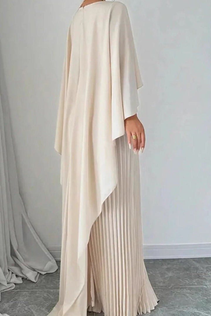 Close-up of a luxurious pleated cape on a women's maxi dress, ideal for an elegant evening or gala event.