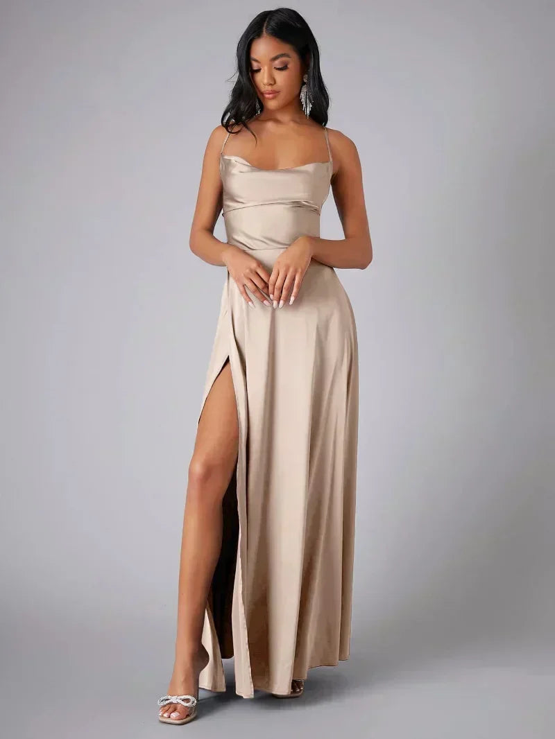 Elegant women's maxi evening dress with high slit, open back, & draped neckline. Perfect for formal occasions.