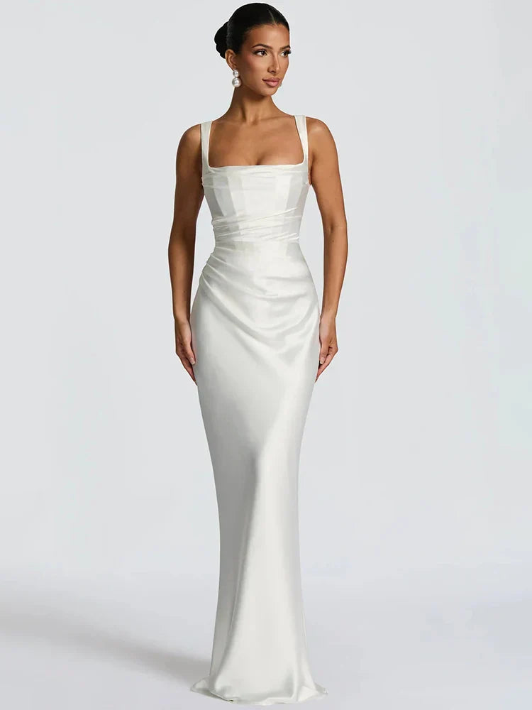 Formal women's maxi dress for wedding guests. Features elegant open back & sleeveless design. Ideal evening wear & party dress.