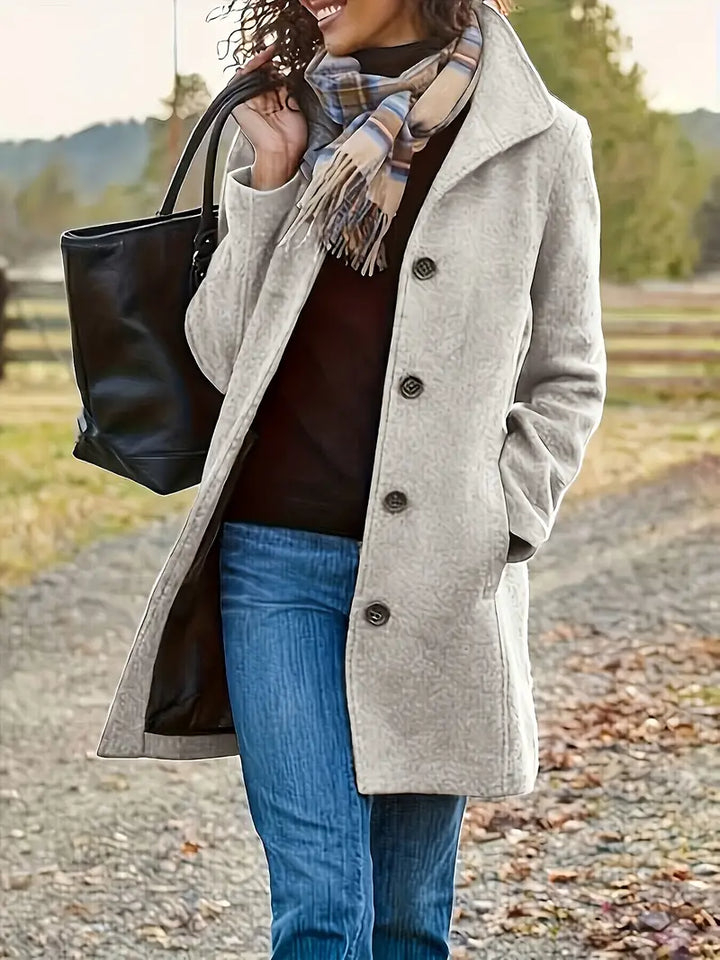Elegant women's mid-length trench coat with button-down front, perfect for stylish fall and winter outerwear.