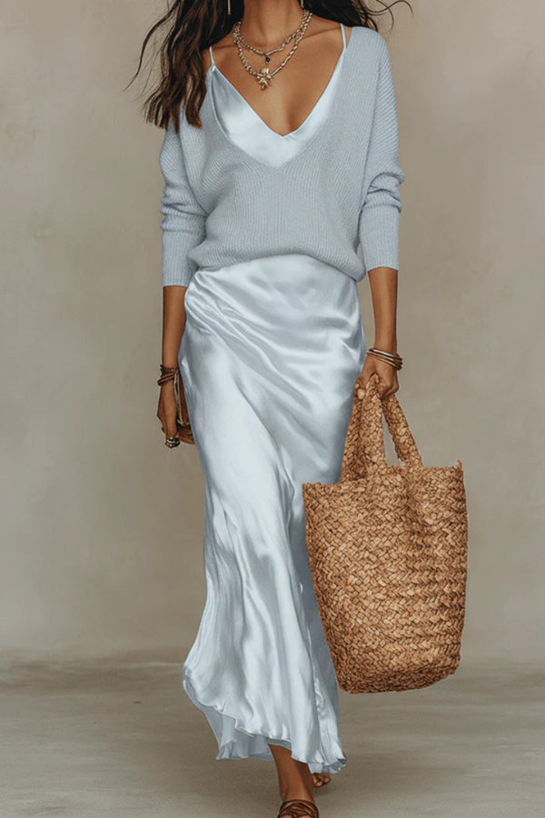 Close-up of elegant women's midi dress & sweater set fabric, highlighting quality & sophisticated style.