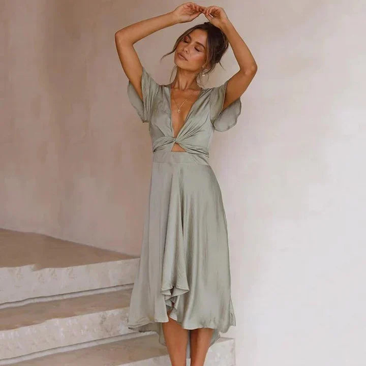 Flowy V-neck midi dress for women, featuring a stylish tie front and flutter sleeves. Ideal for parties or wedding guests.