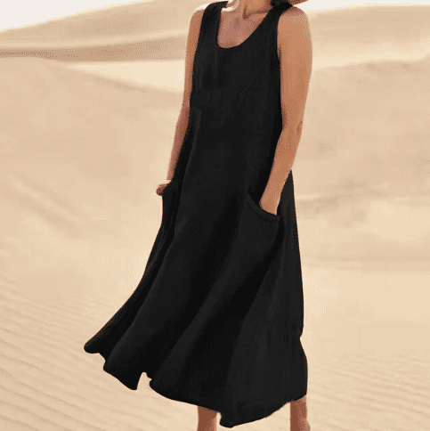 Side view of a flattering women's elegant midi dress, showcasing its relaxed fit and useful pockets for summer.