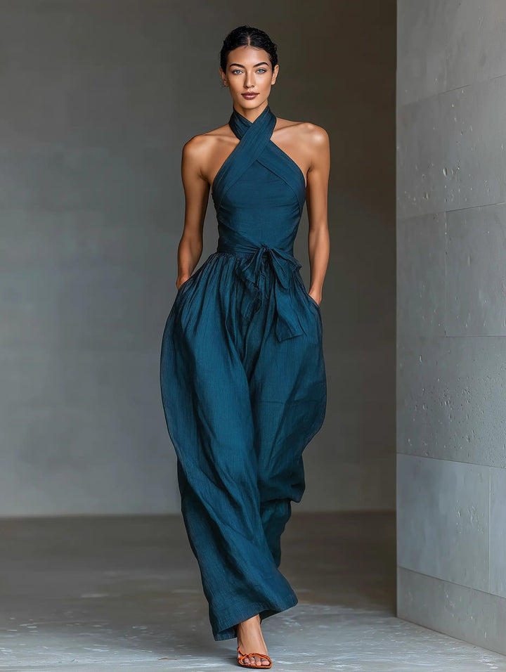 Navy blue sleeveless halter jumpsuit for women, featuring a chic wide-leg design. Ideal for elegant events.