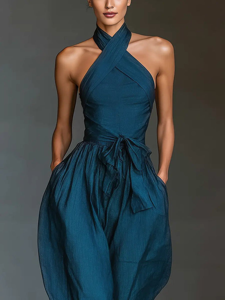 Stylish women's navy wide-leg halter jumpsuit, offering a comfortable and sophisticated look for any occasion.