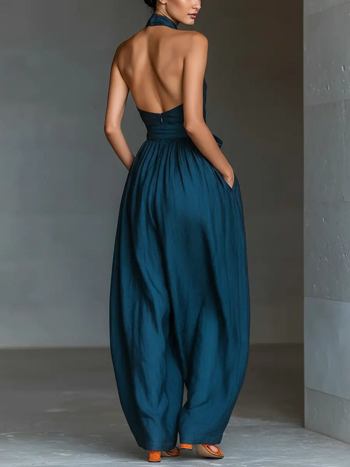 Sophisticated women's navy blue sleeveless halter jumpsuit. Wide-leg design makes it perfect for special events.