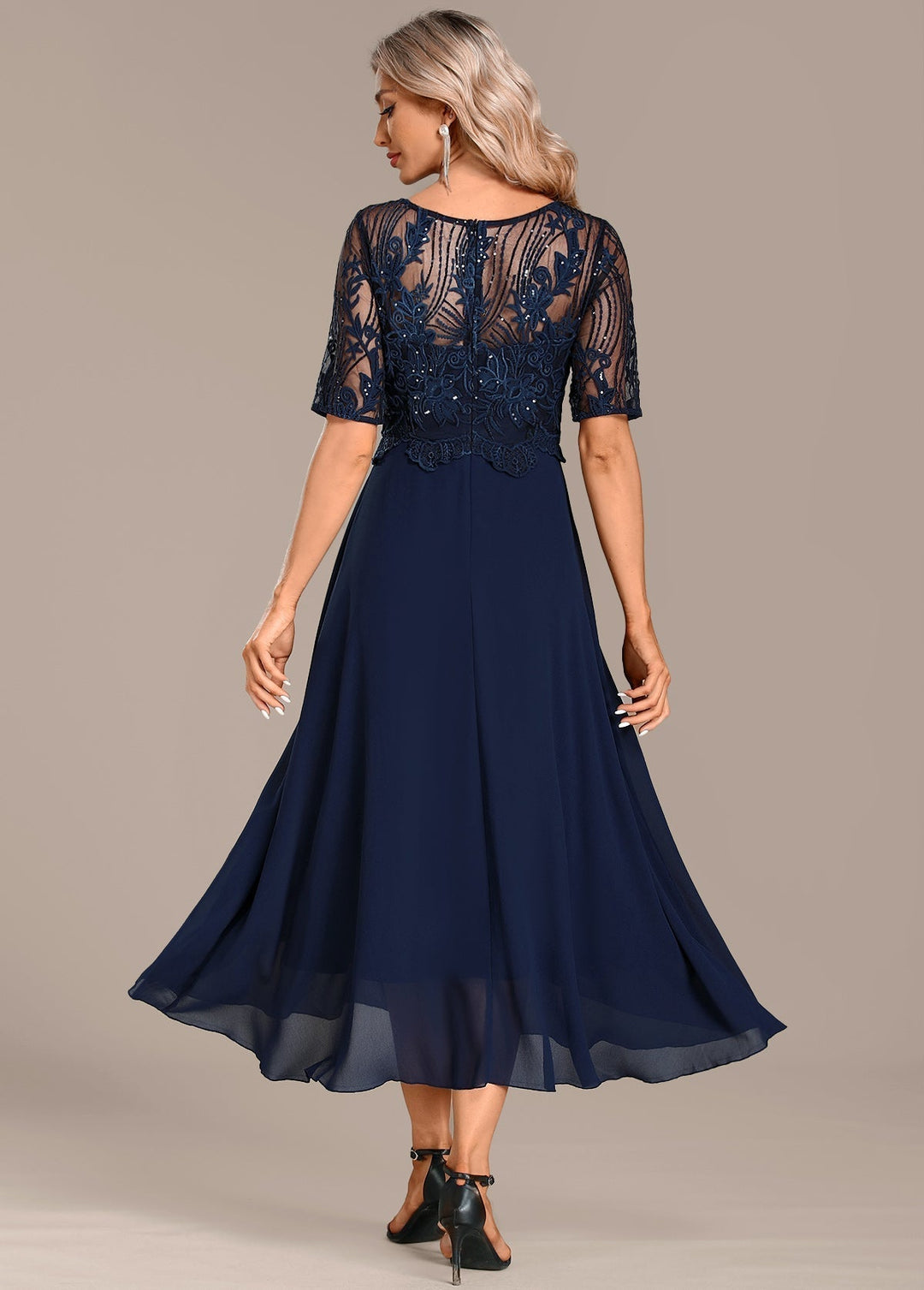 Navy women's midi dress featuring elegant lace panels, a round neck, and short sleeves, suitable for events.
