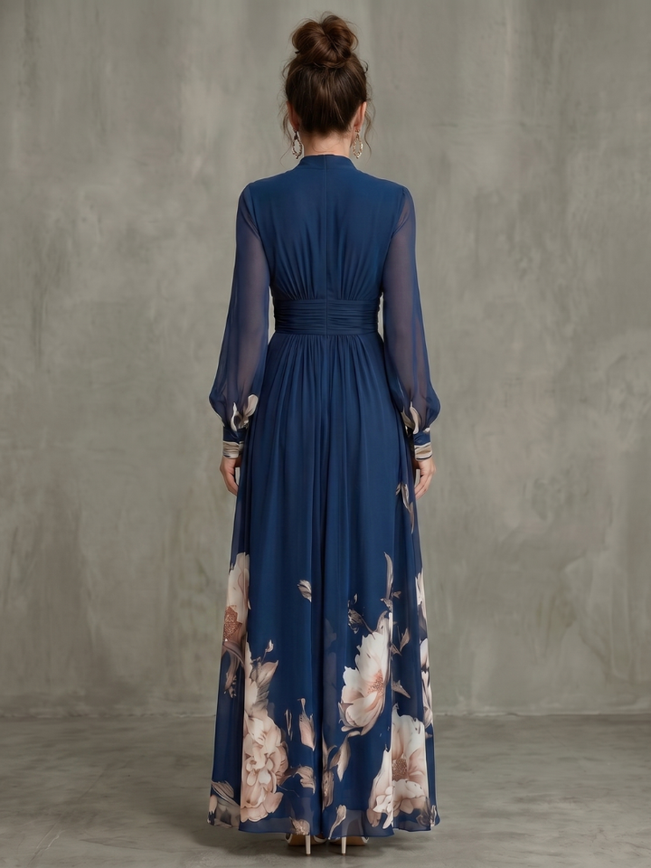 Women's navy V-neck pleated maxi dress with sheer long sleeves. Elegant, flowing, and perfect for parties.