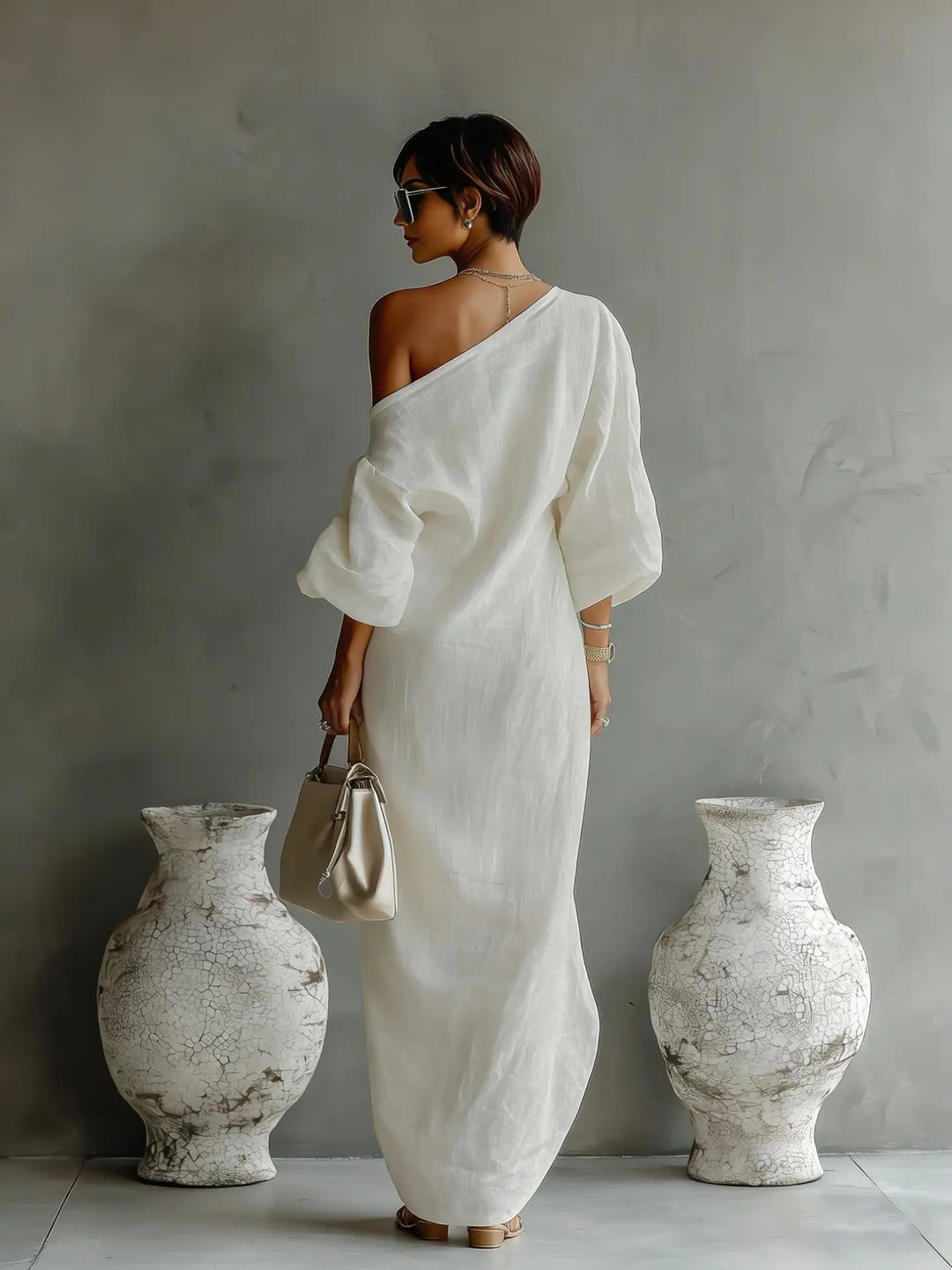 Stylish women's one-shoulder dress with a flowing asymmetrical hem, ideal for summer elegance.