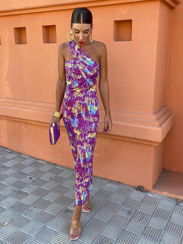 Full-length shot of a women's one-shoulder printed maxi dress, a perfect blend of boho and elegant style.