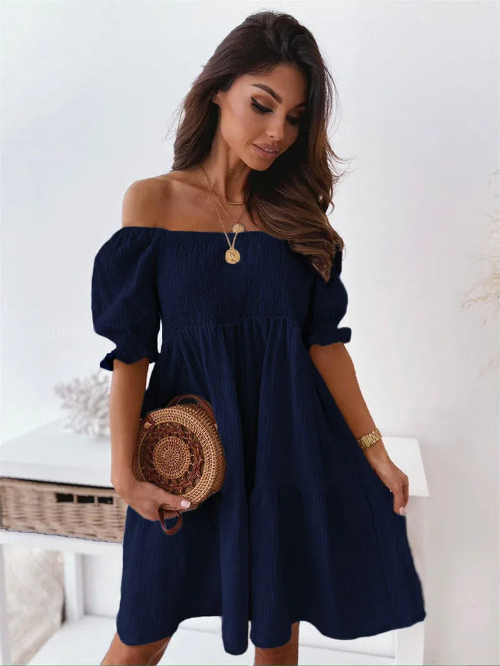 Modern women's one-shoulder mini dress. Elegant a-line style with open back, ideal for summer fashion & parties.
