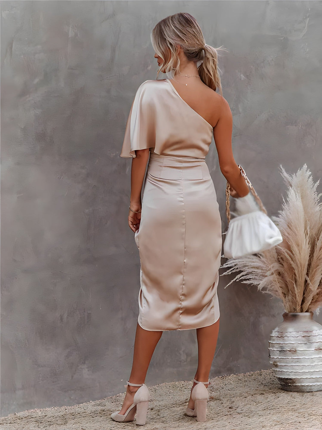 Women's elegant one shoulder wrap midi dress in a soft blush pink, comfortable satin
