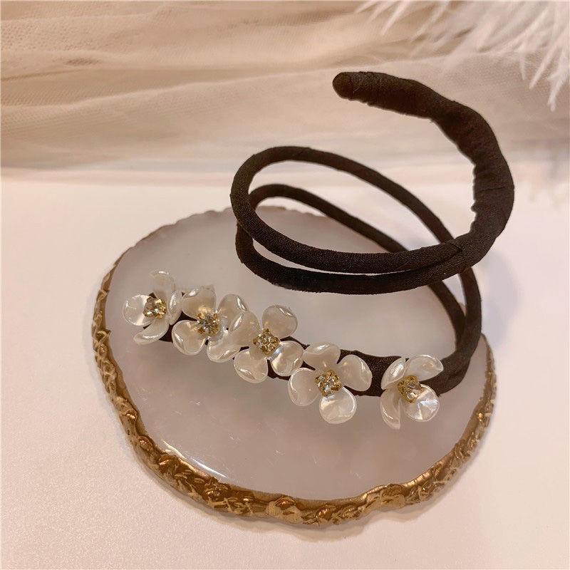 Versatile women's headband with pearl accents, functions as a bun maker