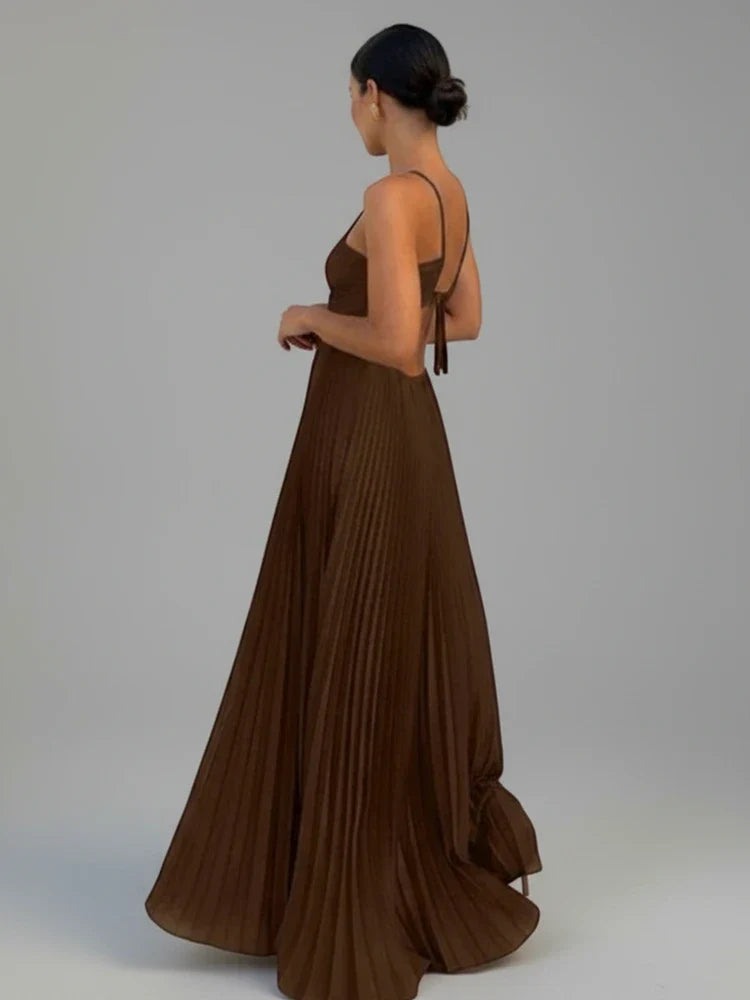 Stylish women's strappy A-line maxi dress with elegant pleats. Ideal long party dress for sophisticated comfort.