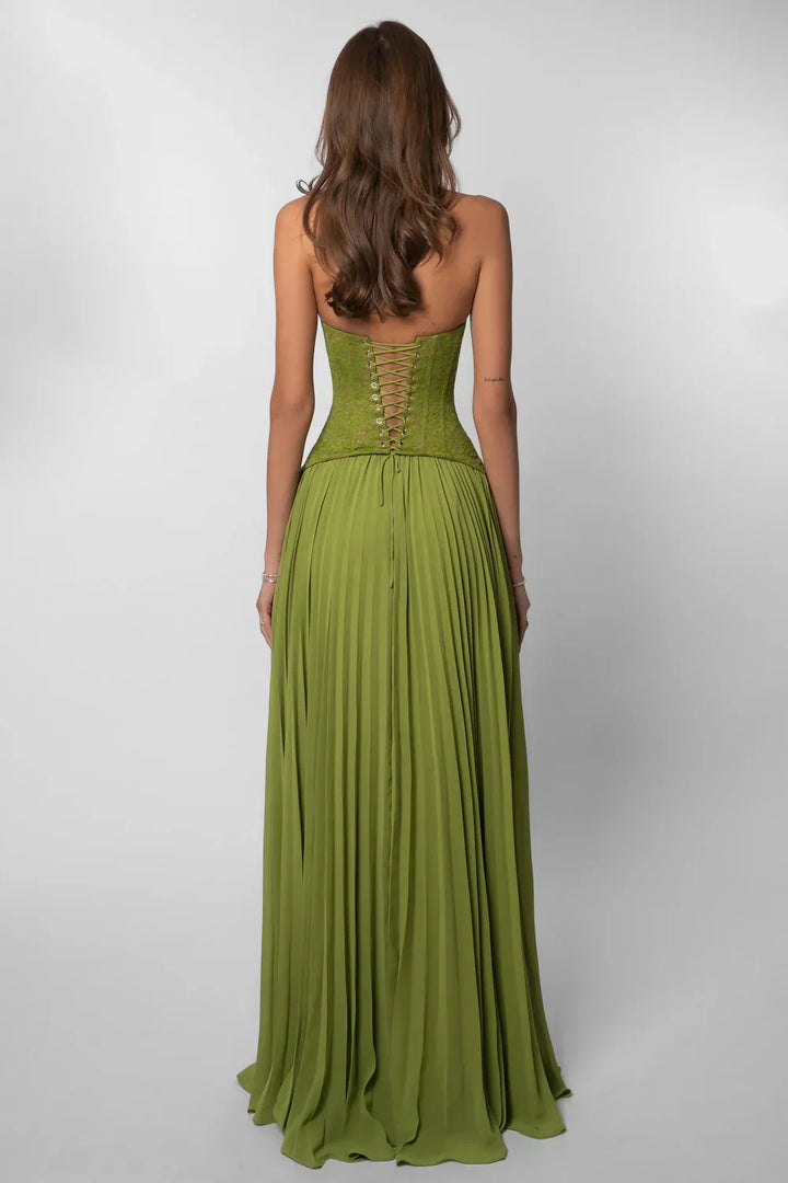Chic green wedding guest maxi dress. Features an elegant pleated skirt and a flattering corset-style top.