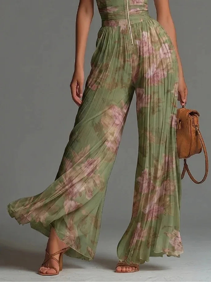 Women's vibrant floral halter jumpsuit with a pleated bodice & flowing wide legs, designed for a chic summer look.