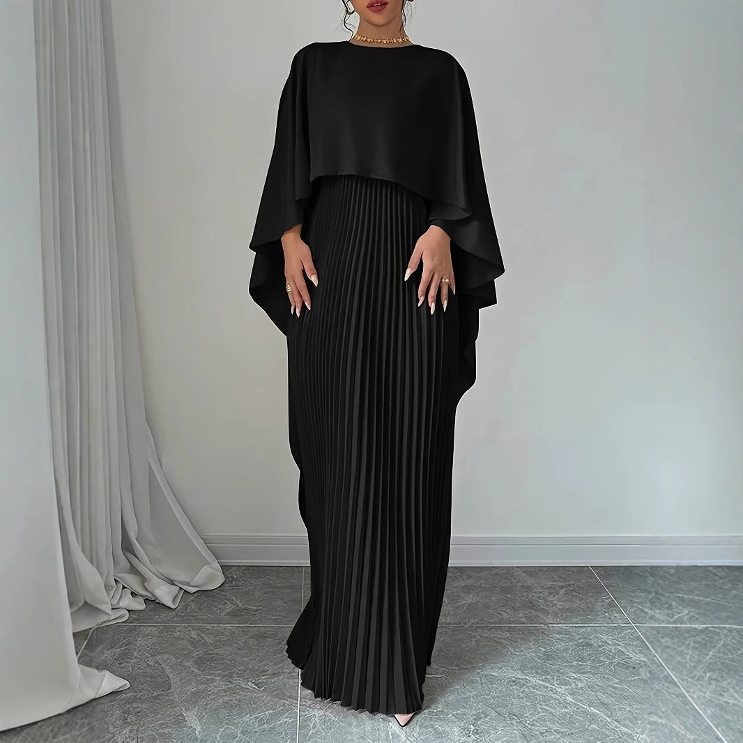 Long elegant women's maxi dress, beautifully pleated with a graceful cape overlay, suitable for special occasions.