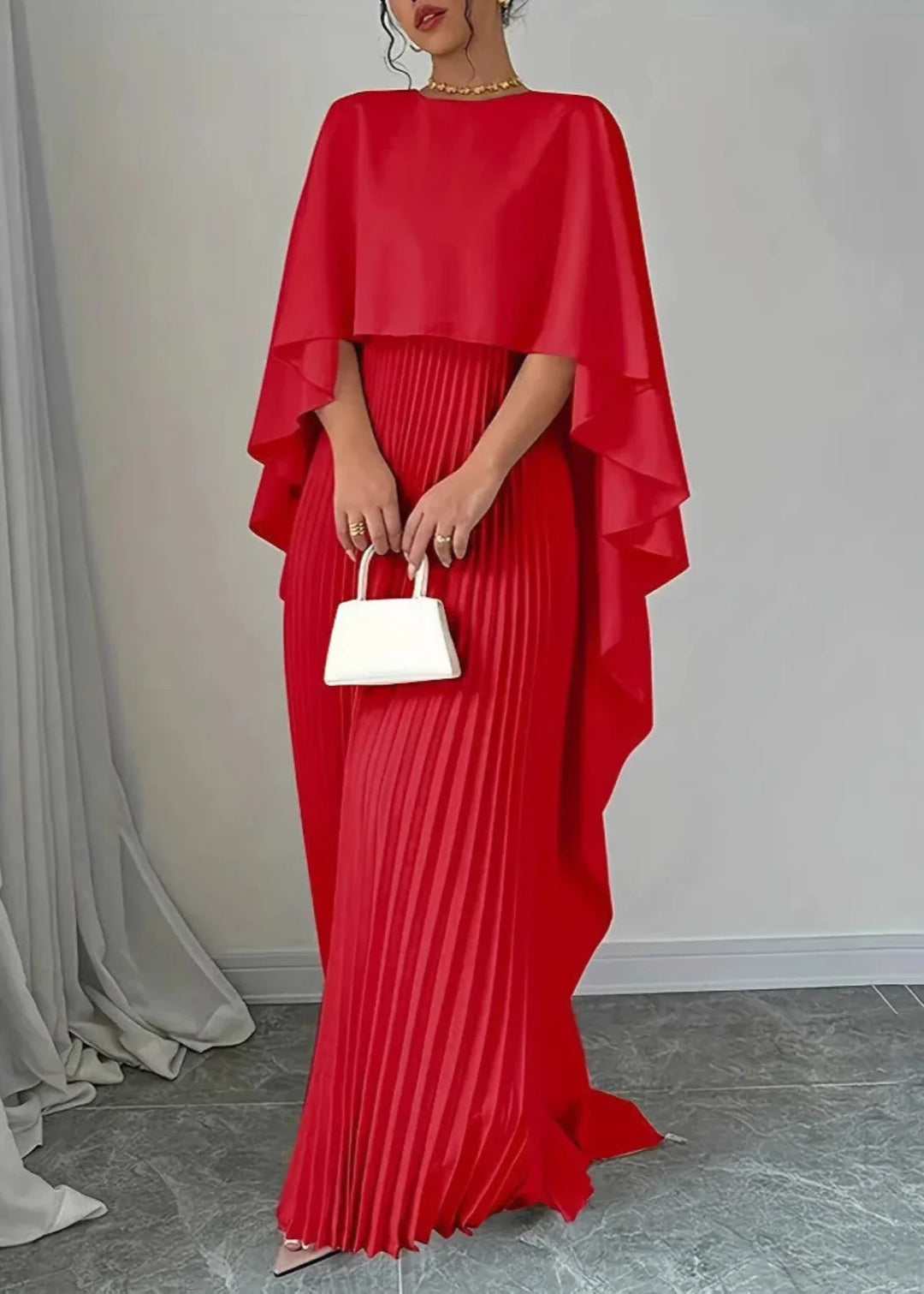 Women's formal wear: a beautiful pleated maxi dress with a sophisticated cape overlay for parties.