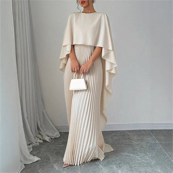 Women's elegant pleated maxi dress with a stylish cape overlay. A versatile, flowy dress for formal and casual wear.