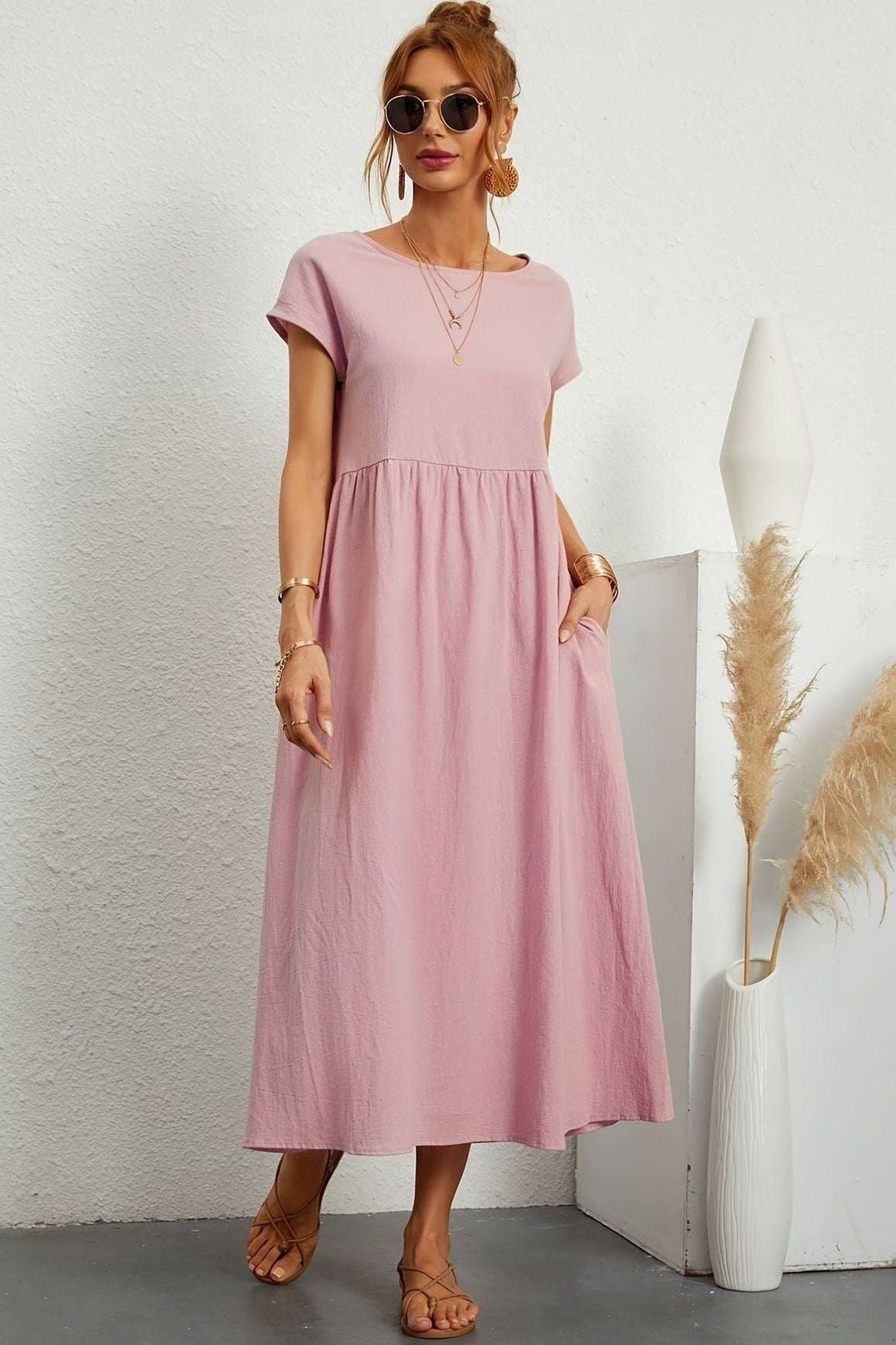 Summer fashion: elegant pleated midi dress for women. Versatile for casual or party wear.