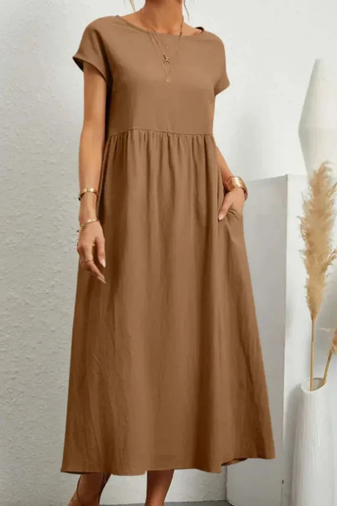 Feminine women's pleated midi dress. Elegant design, versatile for all stylish occasions.