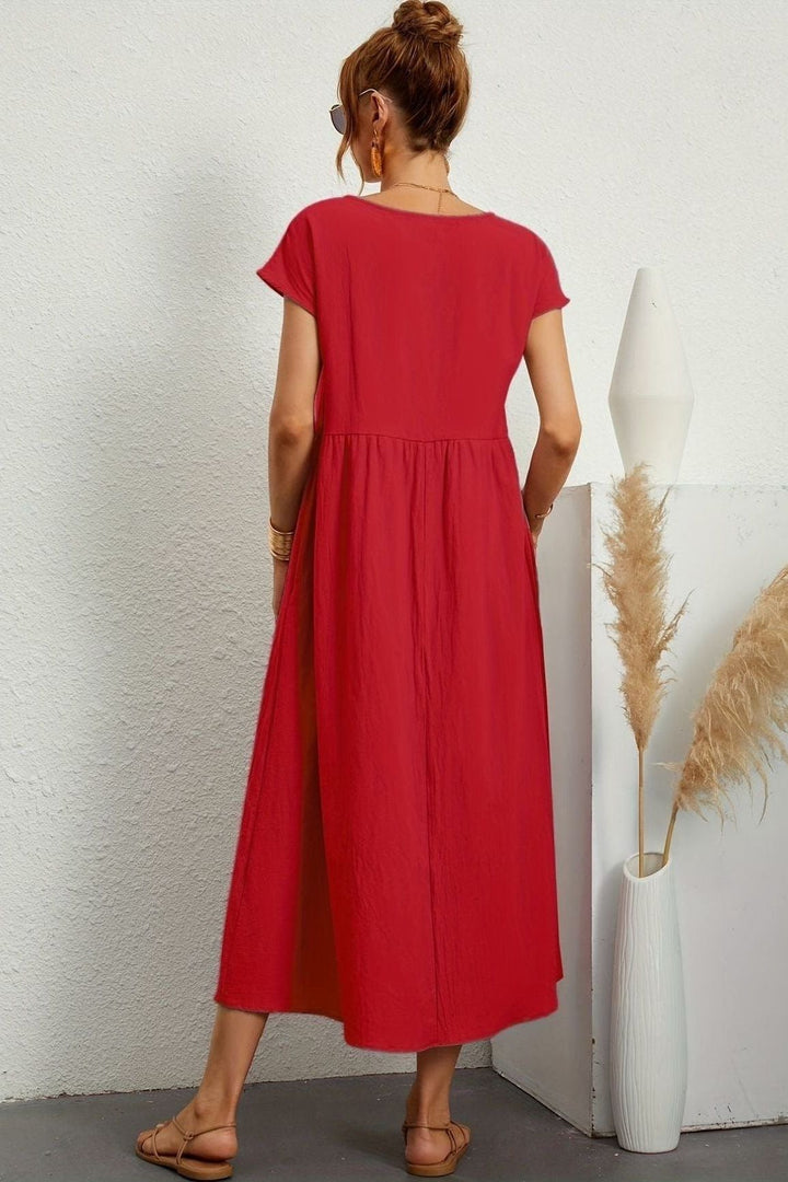 Women's elegant pleated midi dress, a versatile piece for spring and summer fashion.