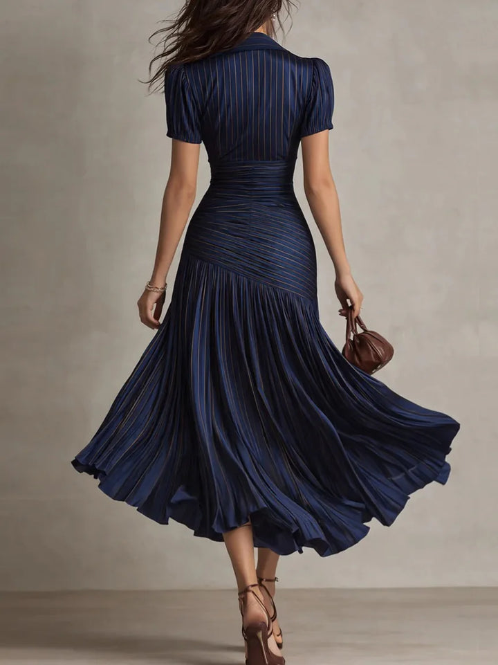Flowing beige women's elegant pleated midi dress, A-line style, perfect for chic occasion wear.