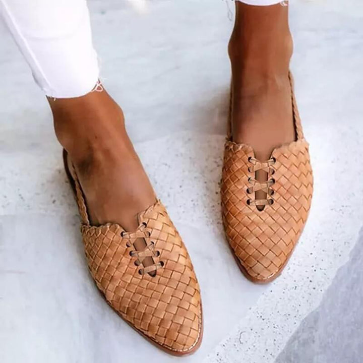 Elegant women's pointed toe flat loafers with lace-up detail. Comfortable slip-on design for versatile everyday wear.
