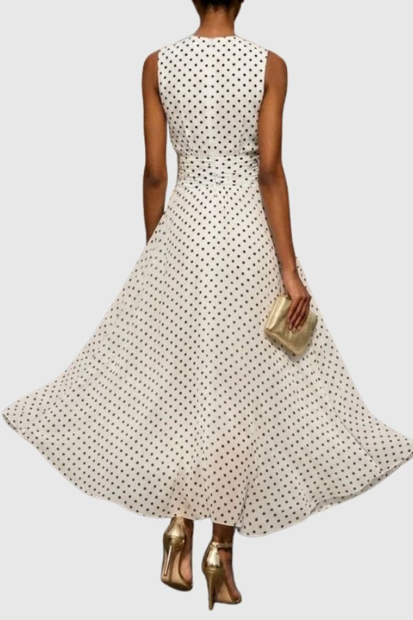 Sleeveless polka dot maxi dress with elegant ruffle hem, ideal for a chic summer evening occasion.