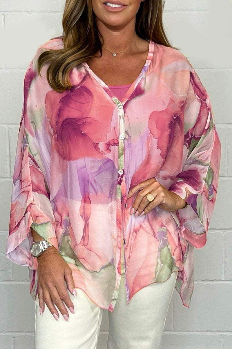 Detailed view of a women's elegant printed blouse. Lightweight fabric & unique pattern, great for versatile spring style.