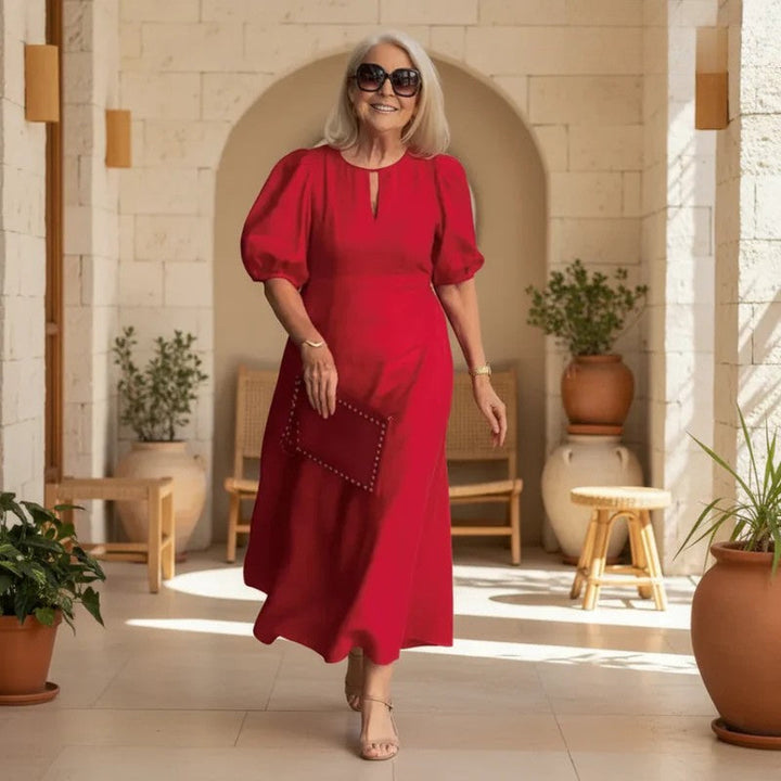 Elegant women's puff-sleeve midi dress, chic and flattering for stylish spring/summer fashion.