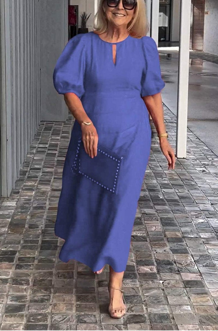 Flattering elegant women's dress featuring stylish puff sleeves and a comfortable midi length.