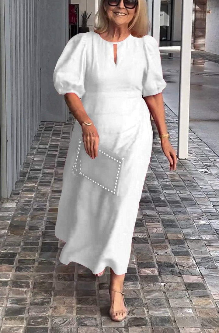 Women's elegant puff-sleeve midi dress, a stylish and flattering choice for spring/summer fashion.