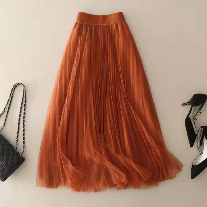 Chic blue high-waist pleated midi skirt for women. Flowy A-line design, perfect for elegant summer fashion.