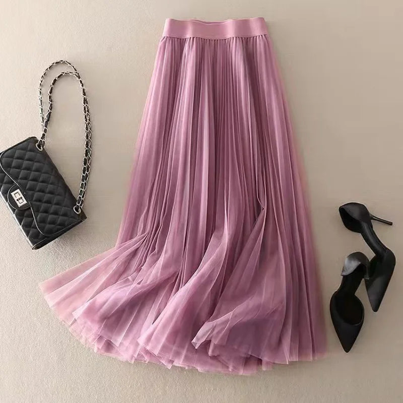 Elegant beige pleated flowy A-line midi skirt for women. High-waist design, ideal for casual summer fashion.