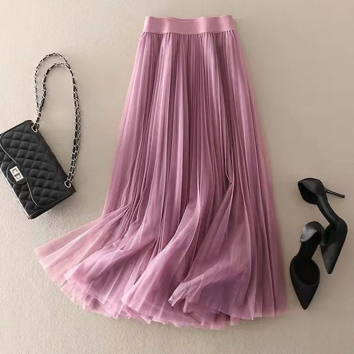 Elegant beige pleated flowy A-line midi skirt for women. High-waist design, ideal for casual summer fashion.
