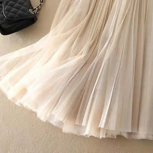 Women's elegant blue pleated flowy A-line midi skirt. High-waist, perfect for casual summer wear.