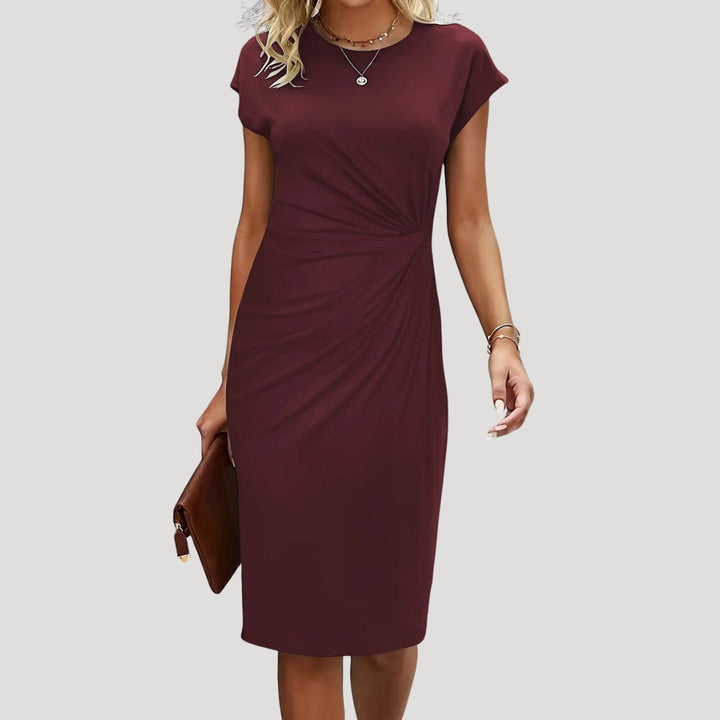 Sophisticated women's elegant midi dress, ruched and fitted, suitable for special occasions or formal events.