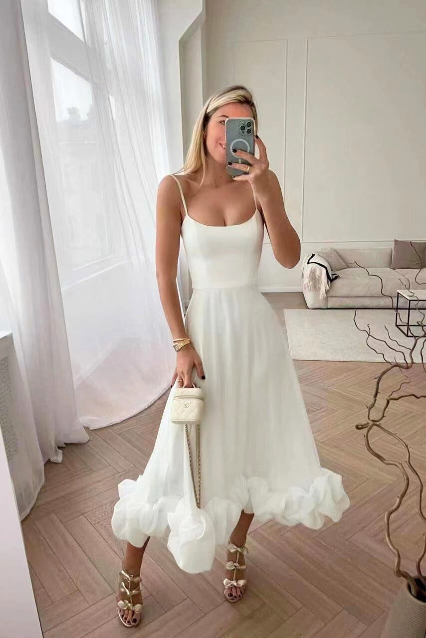 Stunning wedding guest maxi dress with a sophisticated scoop neck, spaghetti straps, and elegant ruffle detail.