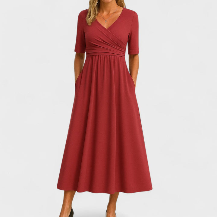 Detail of 3/4 sleeves and flattering wrap waist on an elegant women's A-line semi-formal midi dress.