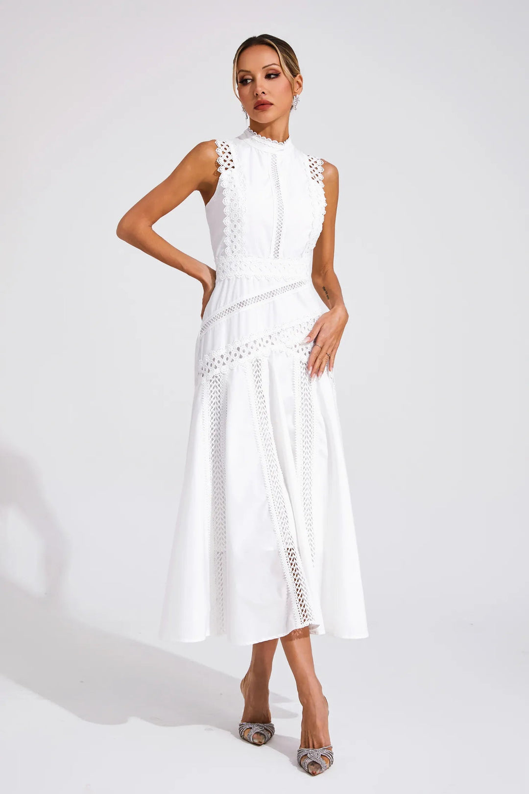 Chic women's high neck sleeveless midi dress featuring delicate lace panels & a flared hem. Ideal for summer parties.