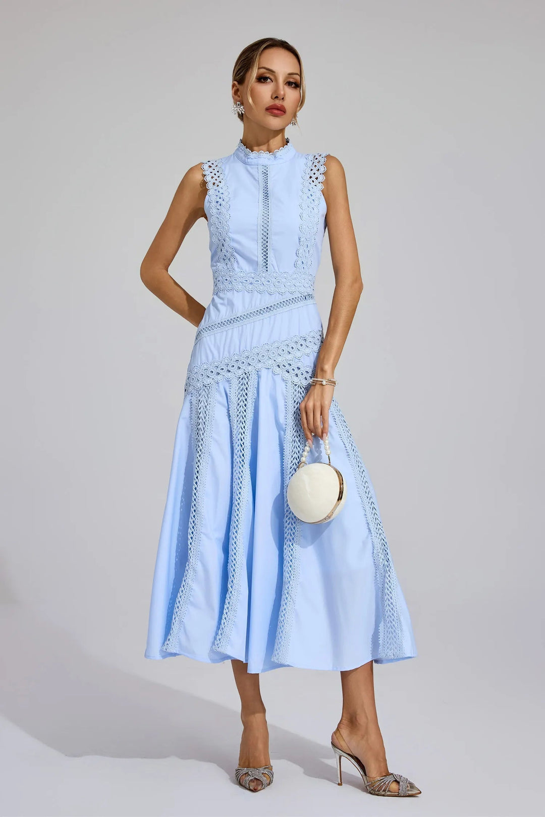 Stylish women's sleeveless midi dress with intricate lace panel details, a high neck & flared silhouette for summer.